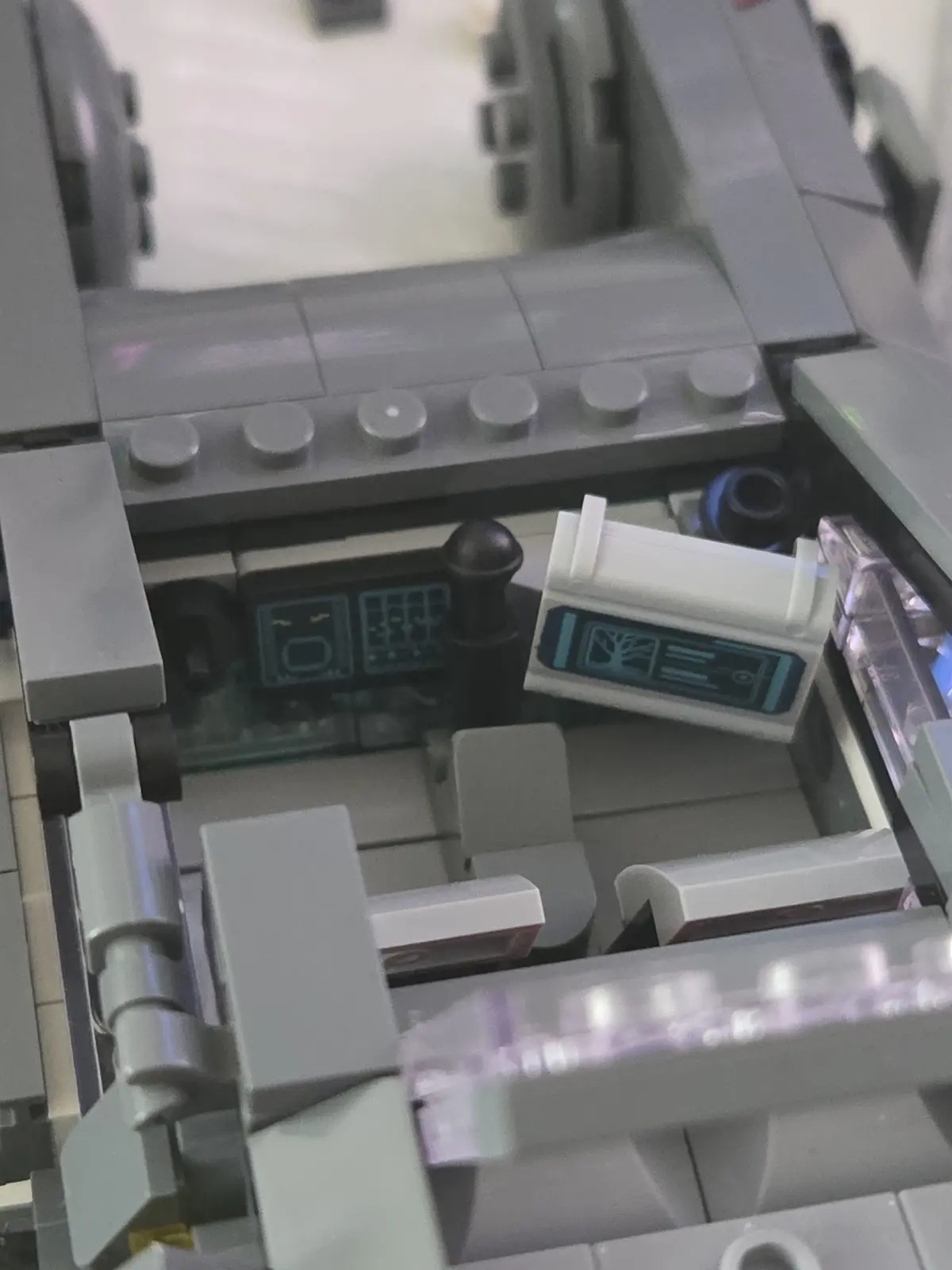 Cockpit interior of the Lumibricks K's Spinner 23001 showing the seat, printed controls and side console