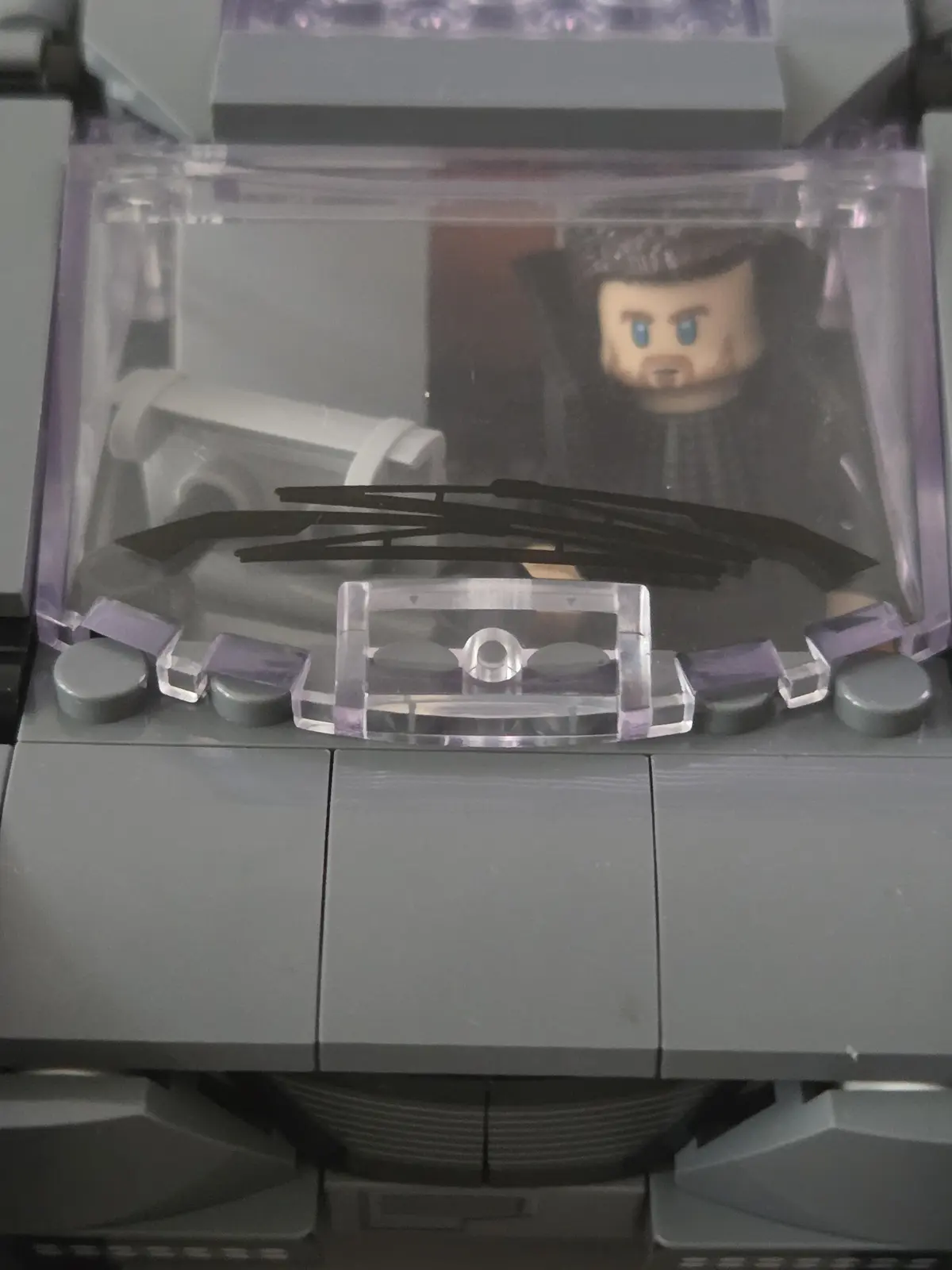 Officer K seated inside the illuminated cockpit of the Lumibricks K's Spinner