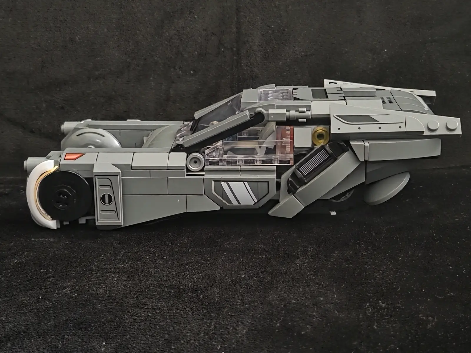 Side profile of the Lumibricks K's Spinner 23001 showing its low nose and raised rear bodywork