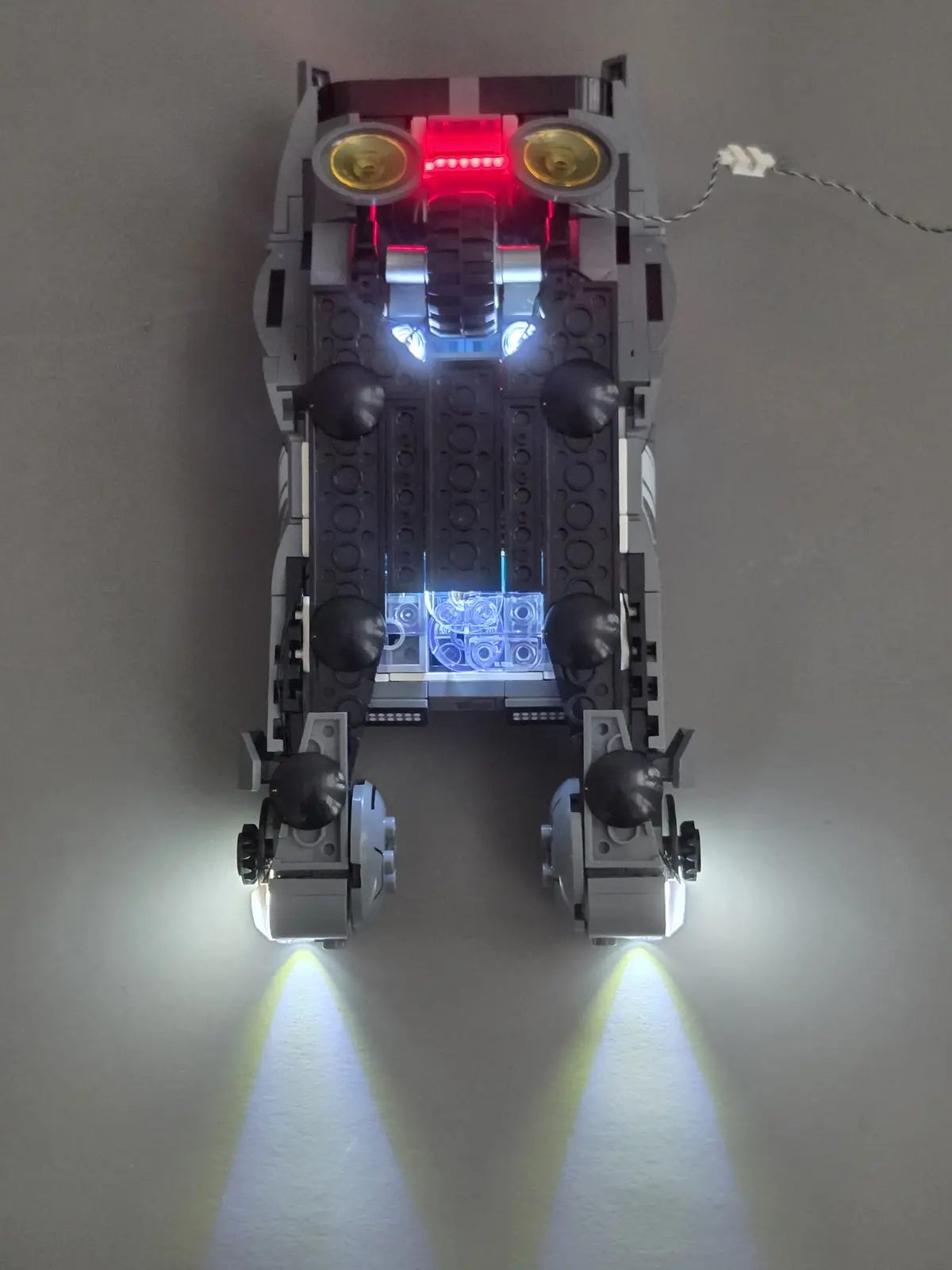 Underside of K's Spinner showing the cool white thruster lights and hidden rolling wheel