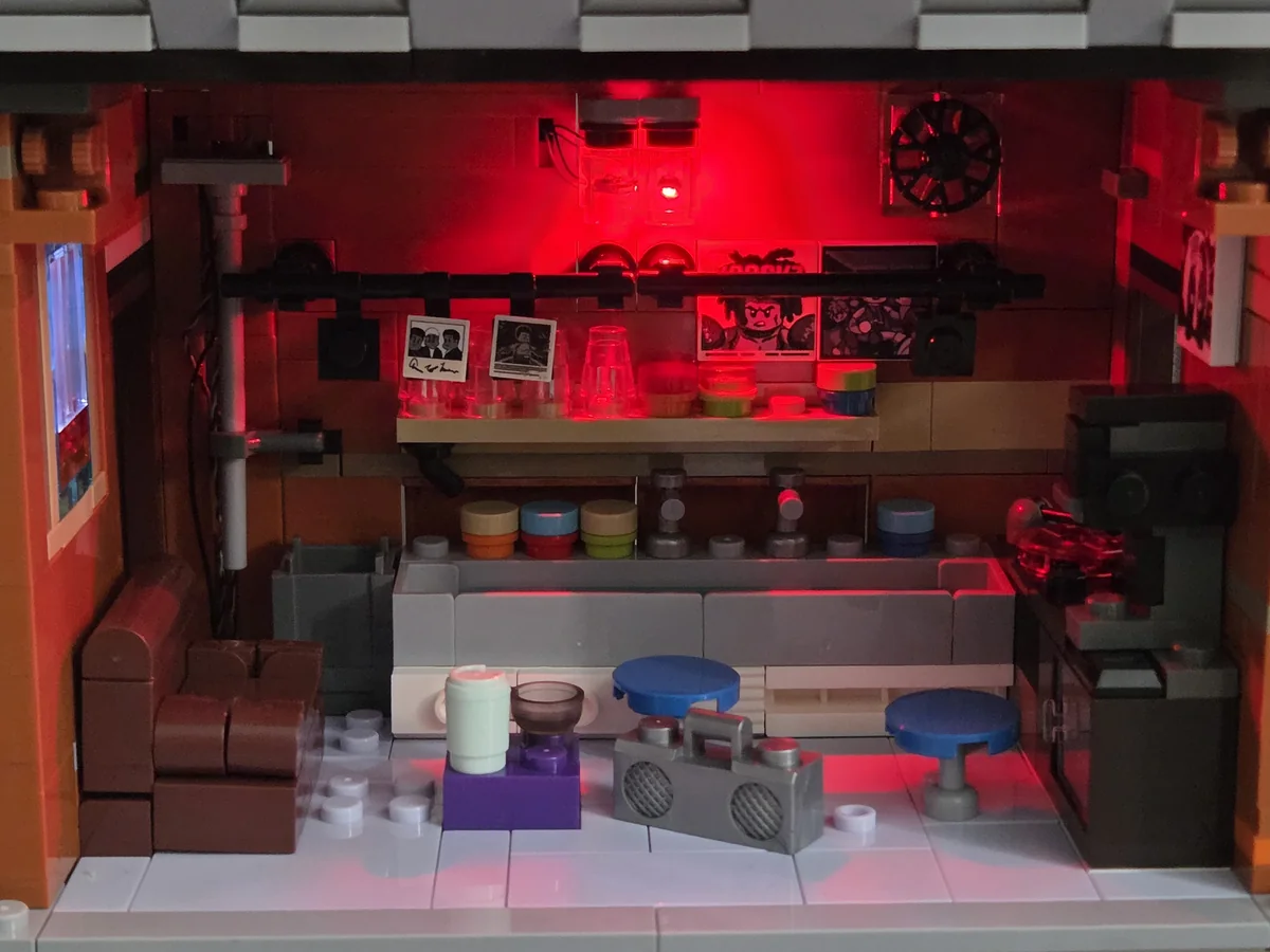 The upper-floor darkroom illuminated by its red LED light
