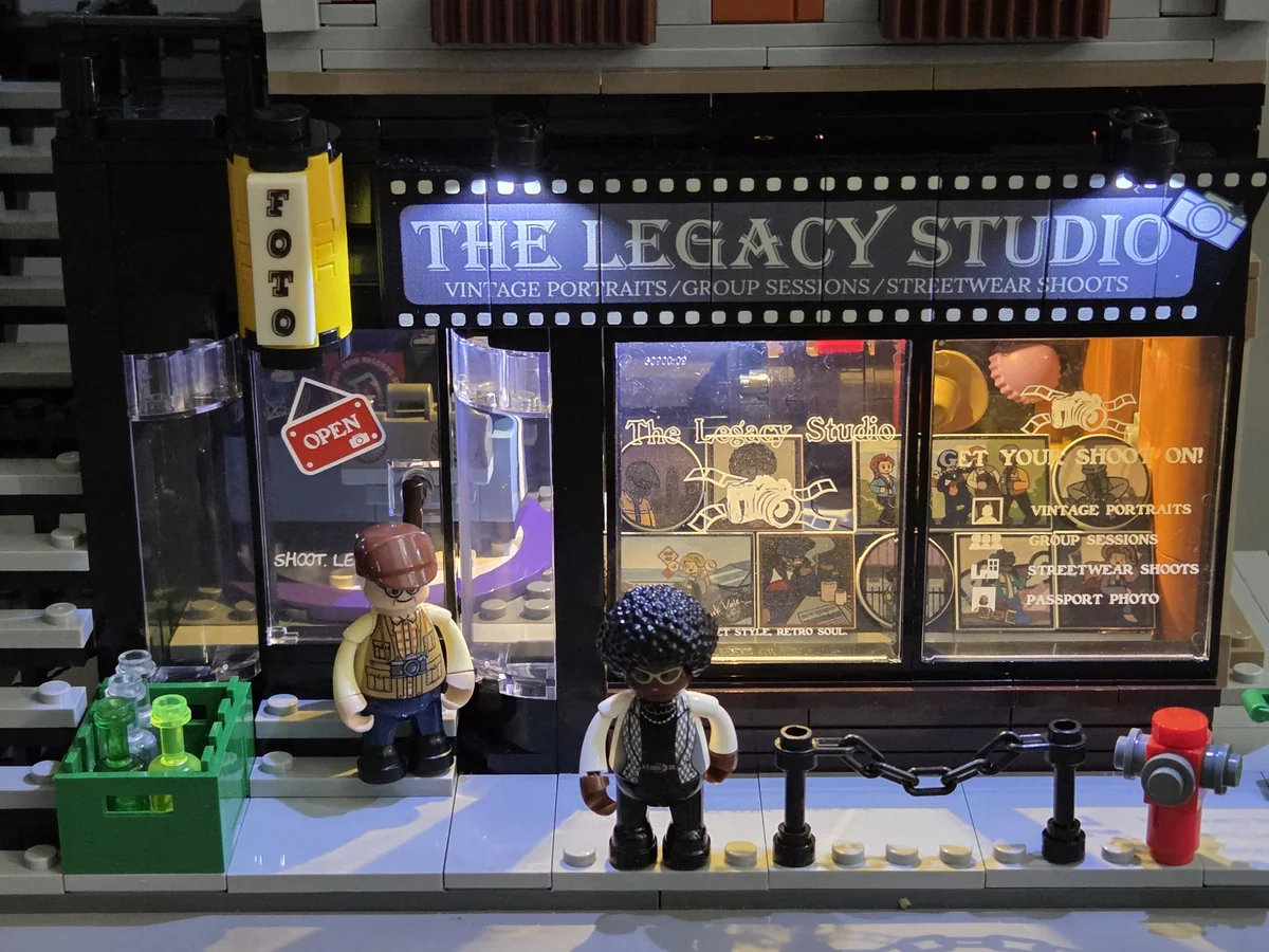 The illuminated shopfront and printed windows on Lumibricks Corner Photo Studio 19016