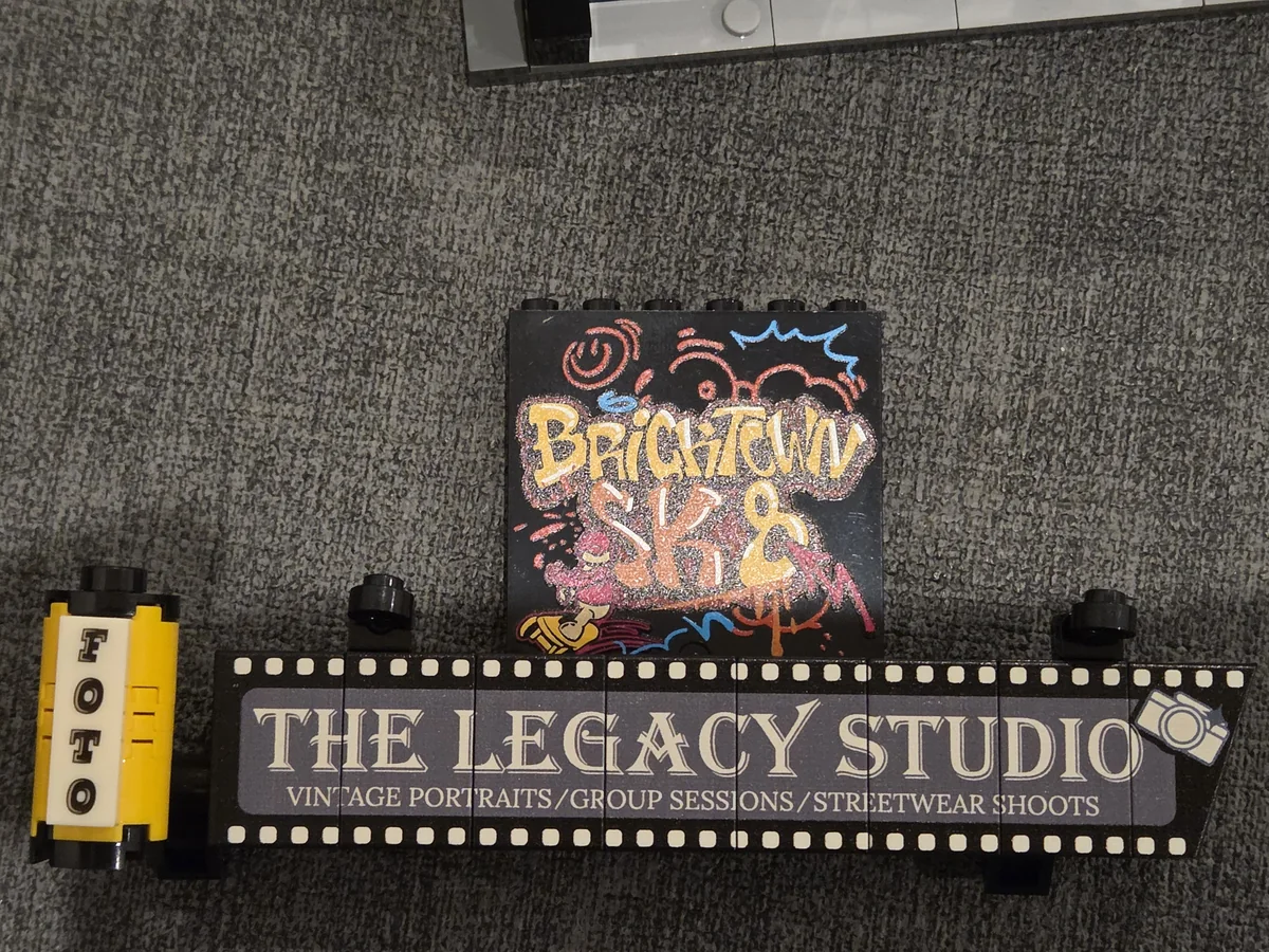 The printed Legacy Studio sign, FOTO light box and graffiti panel from Corner Photo Studio 19016