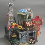Completed IAMBRICK Doomsday Gas Station model with tower, roadside sign, crane, off-road vehicle and two figures