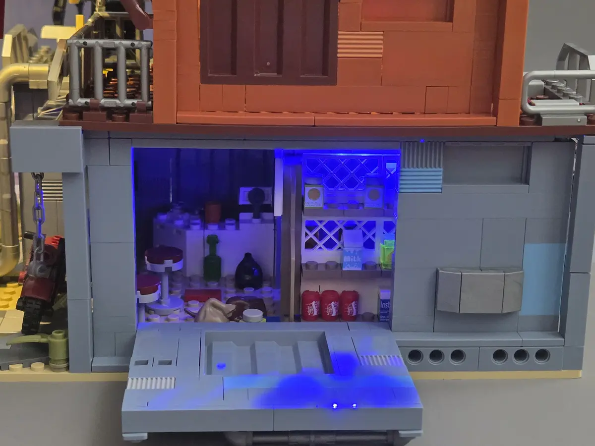 Open rear panel showing the blue-lit ground-floor convenience store shelves