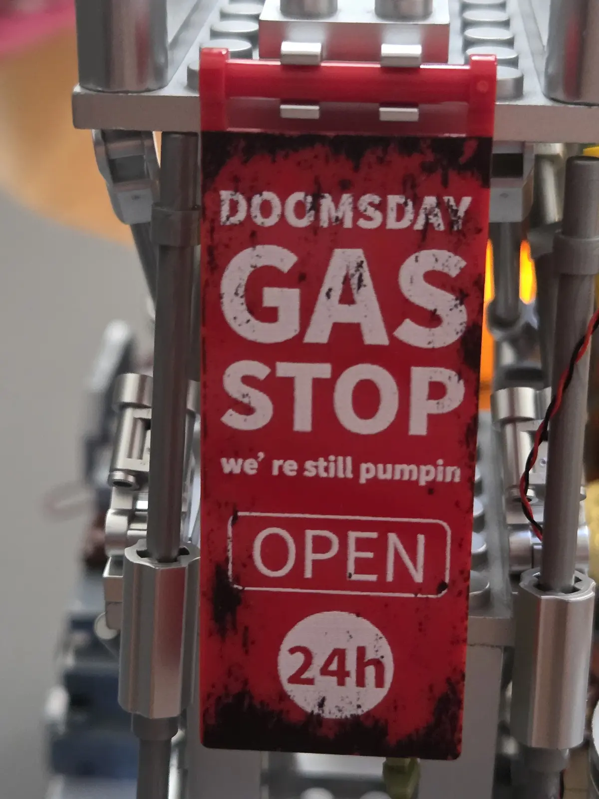 Weathered printed Doomsday Gas Stop graphic attached to the silver tower