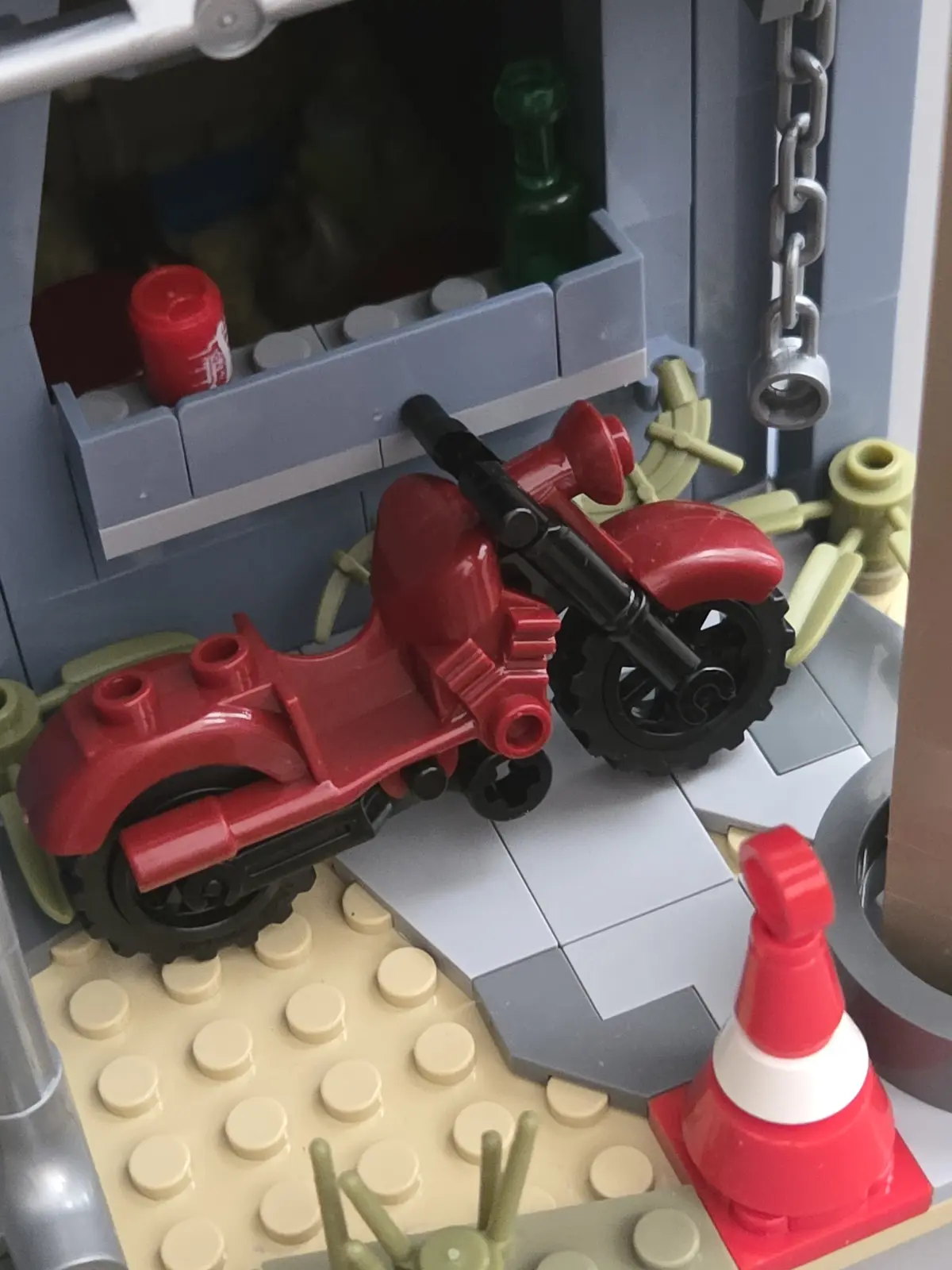Red motorcycle parked beside the IAMBRICK Doomsday Gas Station
