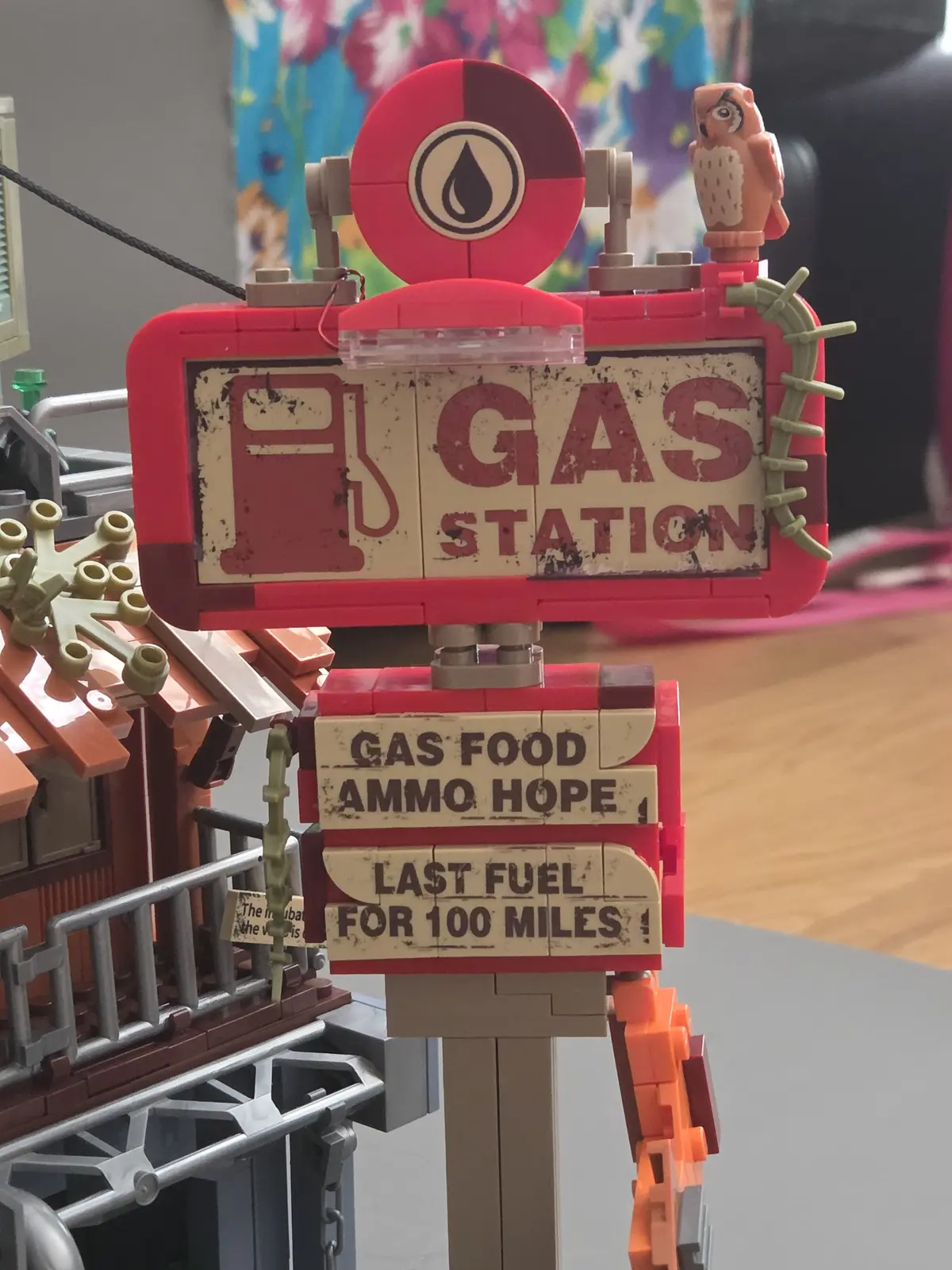 Weathered gas station roadside sign with fuel, food, ammunition and hope notices