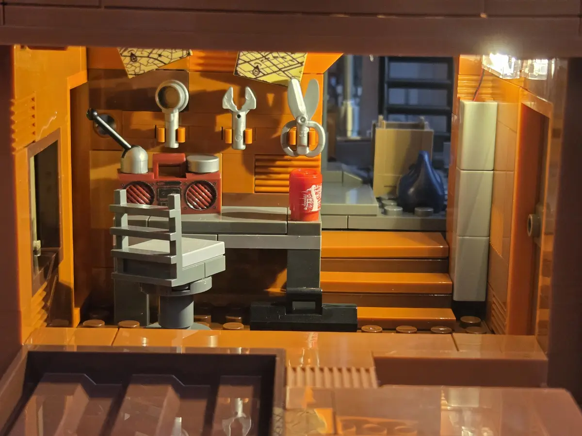 Warm-lit mechanical workshop with tools, radio and workbench