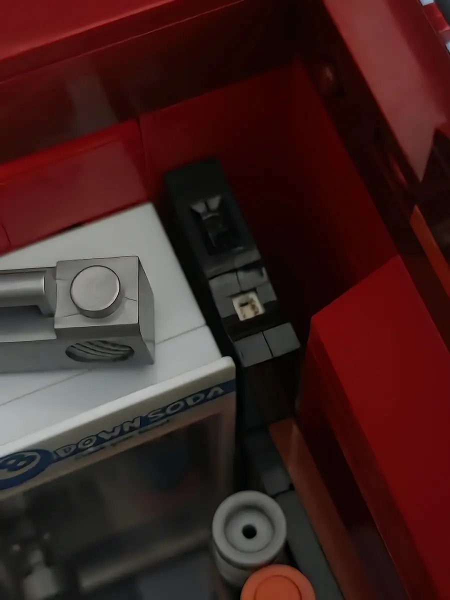 Compact battery pack tucked behind the interior of Lumibricks The Bodega 26 19017