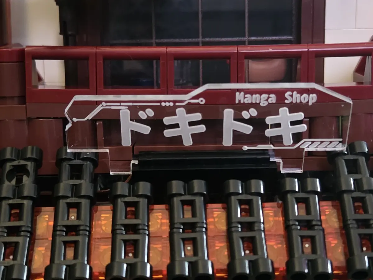 Large transparent Manga Shop sign above the lower roof