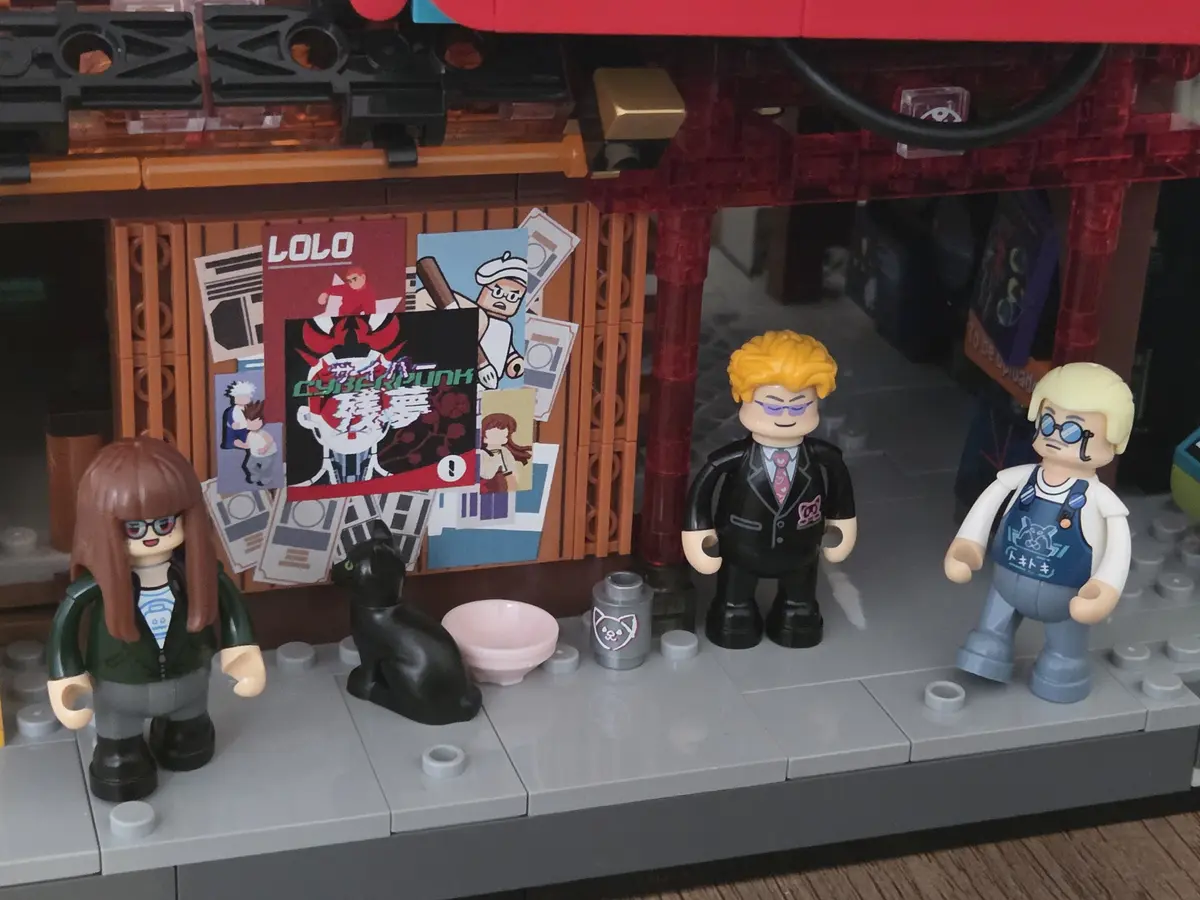 Three Manga Shop minifigures, cat and printed poster wall