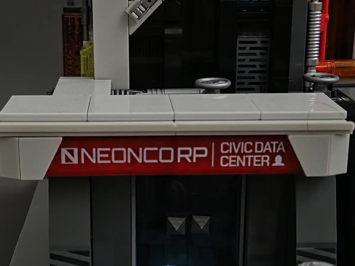 Printed Neoncorp Civic Data Center entrance sign on set 17011