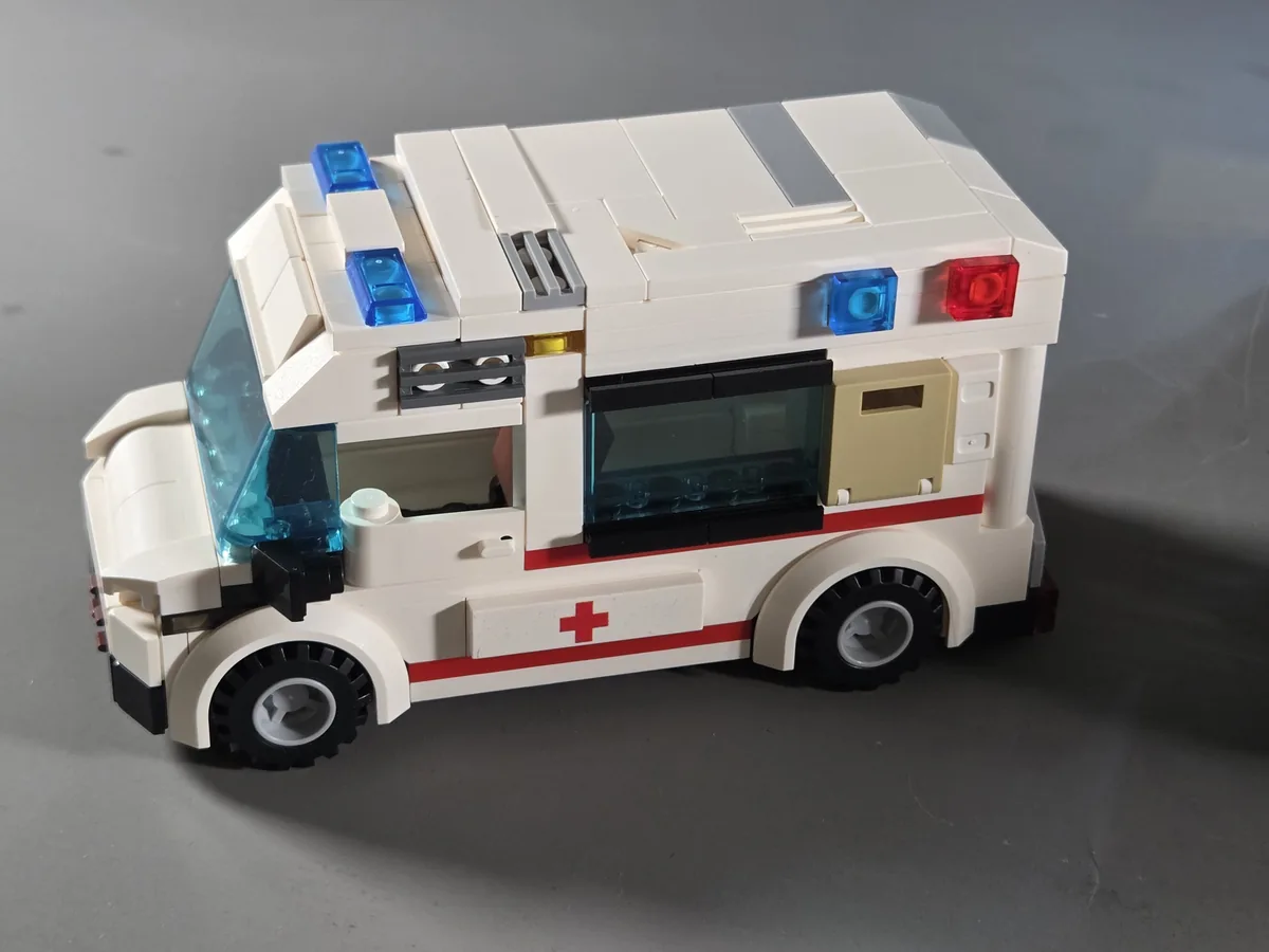 White ambulance with red medical markings and roof lights included in Wrecked Plane Pharmacy