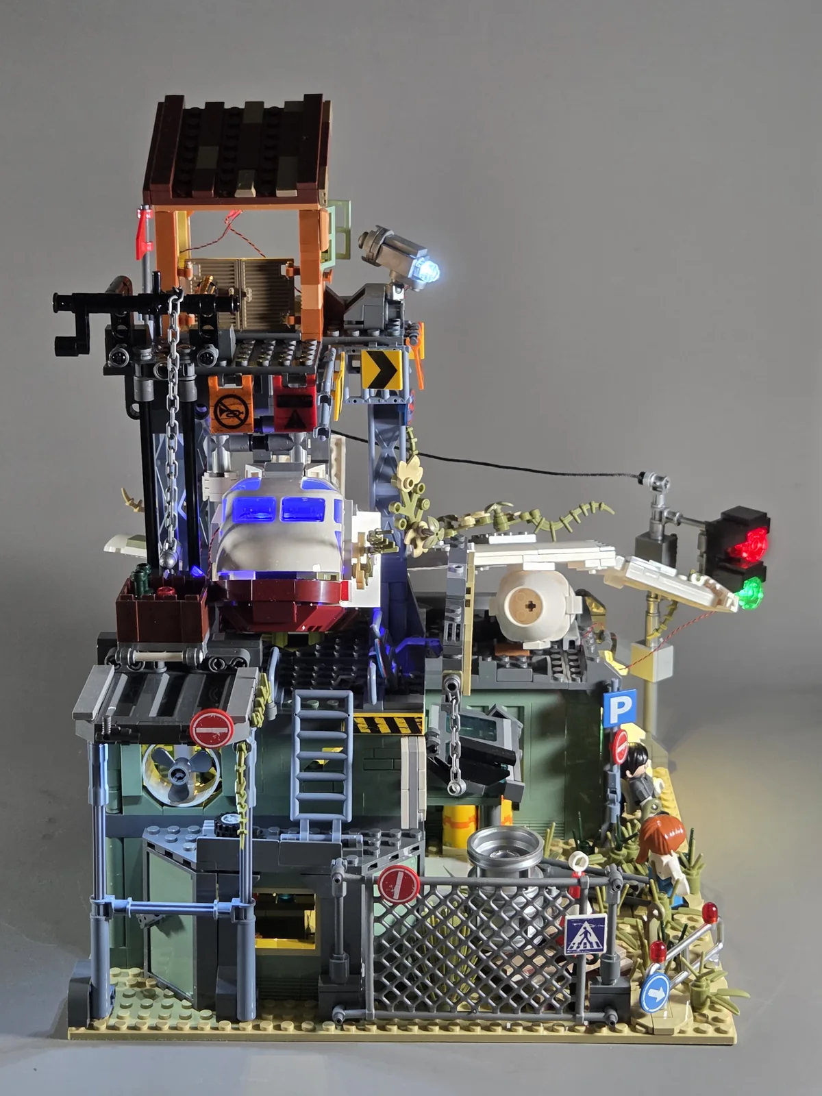 IAMBRICK Wrecked Plane Pharmacy 30902 illuminated with blue aircraft lights and warm ground-floor lighting