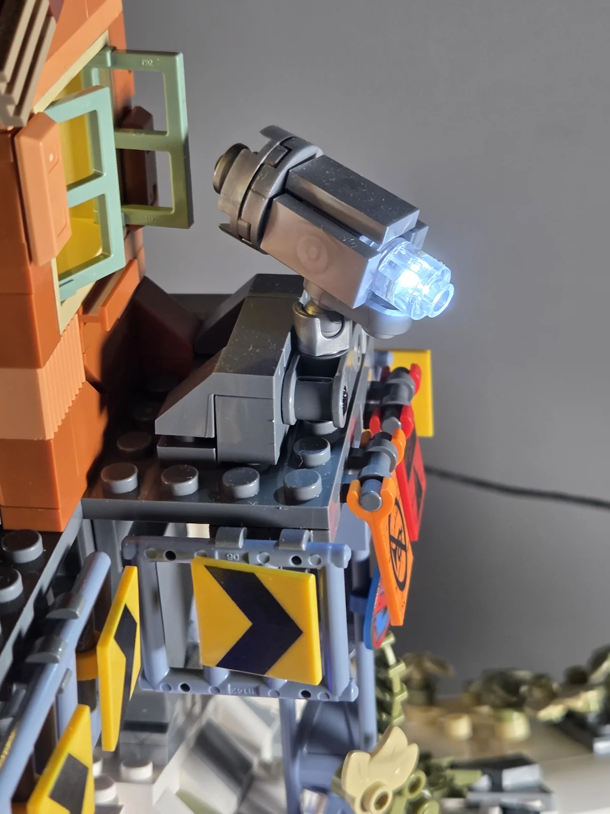 White searchlight illuminated beside the orange watchtower