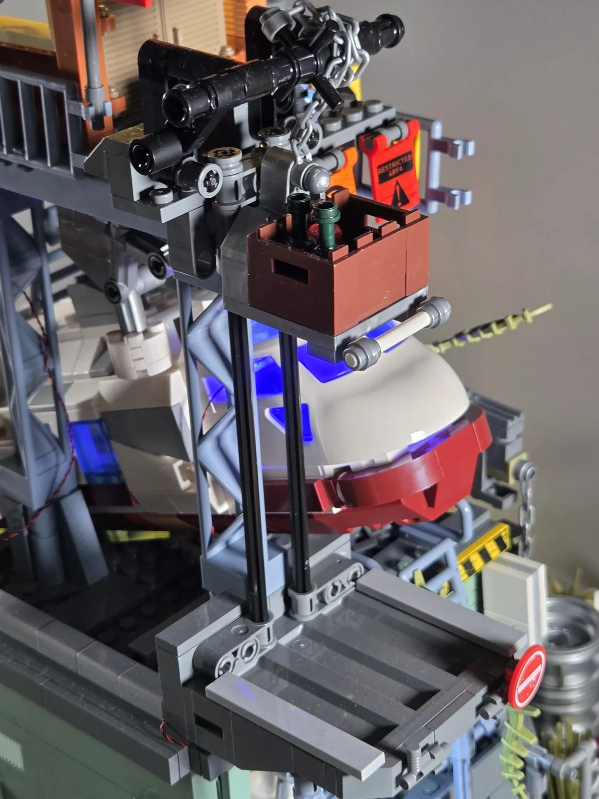 Supply crate raised along the hoist rails towards the watchtower