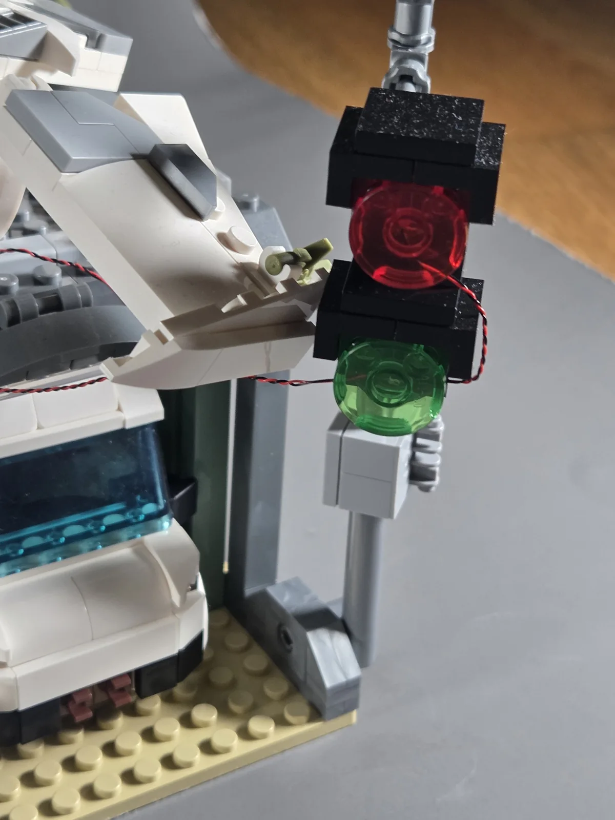 Red and green traffic signals mounted beside the ruined pharmacy