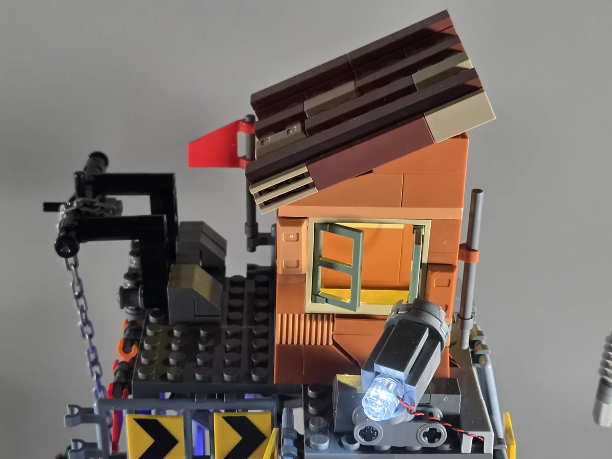 Orange watchtower with sloping roof, window and searchlight